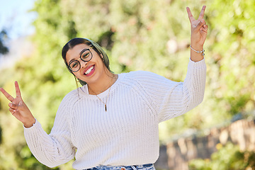 Image showing Peace sign, woman and portrait with a smile outdoor of student on summer holiday and vacation. Motivation, gen z and emoji v hand gesture feeling silly with freedom and female person from Morocco