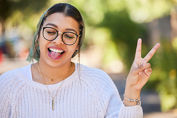 Image showing Peace sign, woman and outdoor with a smile of student on summer holiday and vacation. Motivation, tongue out and emoji v hand gesture feeling silly with freedom and happy young female from Sudan