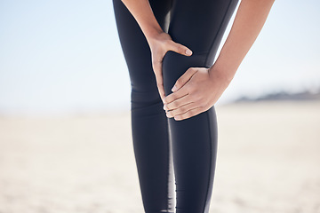 Image showing Fitness, knee pain and running with woman on beach for sports injury, inflammation and accident. Emergency, healthcare and mockup with closeup of runner for exercise, physical therapy and workout