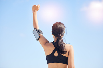 Image showing Woman, fitness and fist pump in achievement for winning, workout success or outdoor exercise. Rear view of female person in celebration for accomplishment or training with sky background on mockup