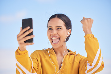 Image showing Happy woman, phone and fitness winning in celebration for workout milestone or outdoor achievement. Excited female person and fist pump in happiness for exercise goals or success on mobile smartphone