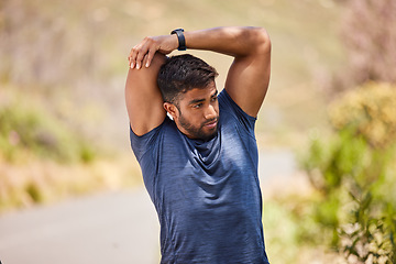 Image showing Wellness, man or runner stretching arms on road in training, fitness workout or cardio exercise outdoors. Thinking body flexibility or healthy Indian male athlete in warm up to start running activity