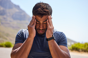 Image showing Stress, runner or man with headache in on road after workout, exercise or running training outdoors. Fitness emergency, sports athlete or stressed person with migraine, head pain injury or burnout