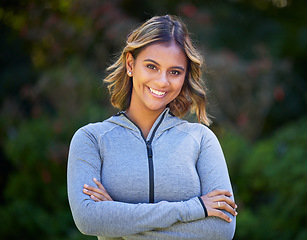 Image showing Runner woman, arms crossed and portrait in park, smile and exercise with fitness training in nature. Indian girl, happy and pride for wellness, health or outdoor workout for body, self care or goals