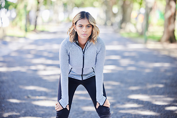 Image showing Fitness, exercise and portrait of a woman outdoor at a park with commitment and focus on wellness. Young female person on a road in nature for a break or rest after workout, running or training