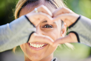 Image showing Nature, portrait and heart hands of a woman for exercise, training and an outdoor workout. Smile, closeup and face of a young athlete or runner with a gesture for love of fitness or running in a park