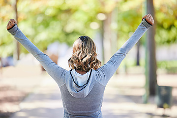 Image showing Fitness, exercise and a woman outdoor with hands raised at a park for celebration, win and success. Back of young female person on a road in nature excited about workout, running or training goals