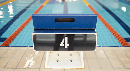 Image showing Empty swimming pool, platform and start competition of water sports, race and contest at diving facility. Background of number on jump block at poolside arena to begin exercise, training and fitness