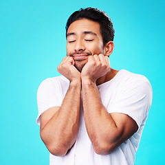 Image showing Calm, relax and man face in studio with sleeping with memory, smile and thinking to remember. Isolated, blue background and happy male model with eyes closed for rest and nap feeling thoughtful