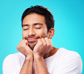 Image showing Sleeping, dreaming and man face in studio with memory, relax smile and thinking to remember. Isolated, blue background and happy Indian male model with eyes closed for rest and nap feeling thoughtful