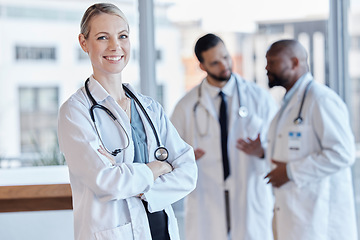 Image showing Woman, happy and portrait of a doctor with arms crossed in a hospital for medical service. Smile, pride and a female nurse or surgeon with confidence while working at a clinic and leadership