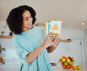 Image showing Learning, education and cards with a happy mother in her home for teaching, growth or development. Smile, school and a female parent or tutor in the kitchen for a private lesson on shape or color