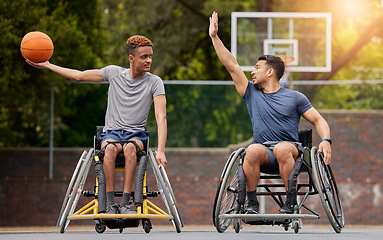 Image showing Sports, basketball and men in wheelchair on court for training, exercise and workout on outdoor park. Fitness, team and male people with disability play with ball for competition, practice and games