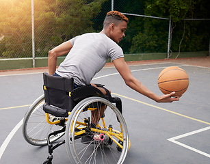 Image showing Sports, basketball court and man in wheelchair for playing competition, challenge and practice outdoors. Fitness, wellness and male person with disability with ball for training, workout and exercise