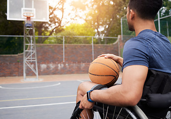 Image showing Sports, basketball court and man focus in wheelchair for playing competition, games and shoot outdoors. Fitness, wellness and male person with disability with ball for training, workout and exercise