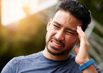 Image showing Sports, headache and man in pain outdoor for injury, vertigo and tired of health problem. Face of asian athlete, runner and training with migraine, fatigue or stress of fitness, exercise and sick