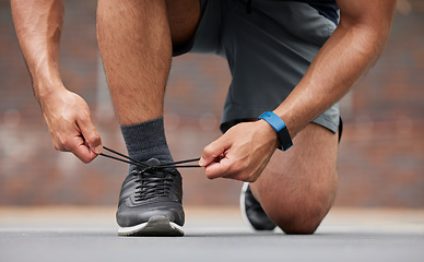 Image showing Person hands, sports and tie shoes for running workout, training and action performance on ground outdoor. Closeup of athlete, runner or lace sneakers for exercise, marathon or prepare cardio fitness