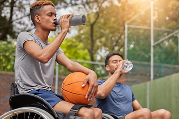 Image showing Men in wheelchair, basketball players or drinking water for sports break, rest or court fitness electrolytes. People with a disability, athletes or workout friends with bottle for exercise recovery