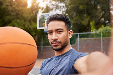 Image showing Man, basketball player and portrait selfie on court for social media, fitness blog or training match vlog. Face, pov or Mexican athlete with ball for exercise, workout and sports photography in games