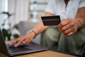 Image showing Woman, laptop and hands with credit card in ecommerce, payment or fintech banking on sofa at home. Closeup female person or shopper with debit on computer app in online shopping, purchase or buying