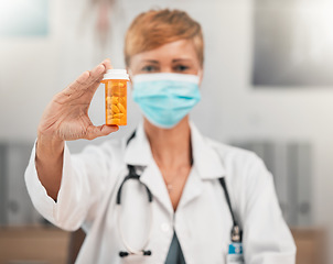 Image showing Face mask, portrait or doctor with pills in hospital clinic for healthcare, medicine and supplements. Wellness, medication or hand of physician holding drugs, prescription product or tablet cure