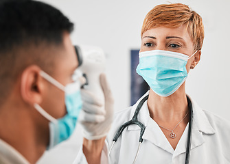 Image showing Laser, mask or doctor with thermometer for healthcare in hospital clinic or medical center. Woman, infrared temperature test or mature nurse screening or checking fever, virus or disease on patient