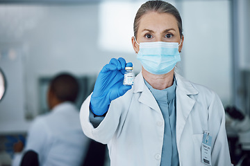 Image showing Portrait of woman doctor with face mask and vaccine bottle in hand at hospital laboratory for covid research. Healthcare, medicine and medical professional with sample for corona vaccination in lab.