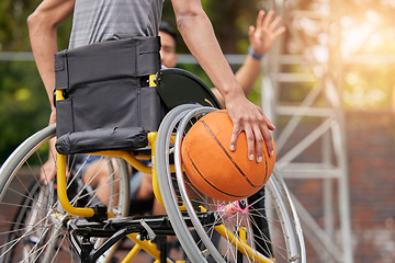 Image showing Sports ball, wheelchair basketball and hands of person playing match competition, challenge or attack on outdoor court. Player, commitment and back of athlete with disability, training and exercise