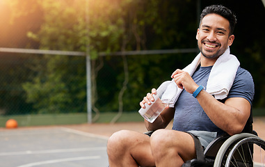 Image showing Basketball player, portrait and athlete in wheelchair drinking water for sports break, rest and fitness electrolytes. Person with a disability, Asian man and bottle for workout recovery on court