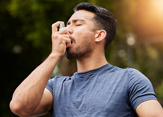 Image showing Man, breathe or asthma pump outdoor in park for help with health risk, cough treatment and air for exercise. Asian male runner, spray and medicine inhaler in nature for lungs, oxygen and wellness