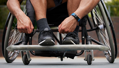 Image showing Sports, wheelchair and hands tie shoes ready for training, exercise and workout on outdoor court. Fitness, start and person with disability tying sneakers for performance, wellness and challenge