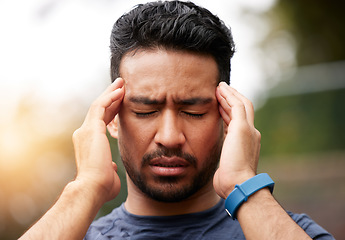 Image showing Face of sports man, headache and pain outdoor for injury, vertigo and tired of exercise problem. Sad asian athlete, sick runner and training with migraine, fatigue or stress of burnout for fitness