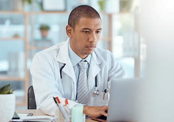 Image showing Doctor, man and typing on laptop in clinic for hospital management, healthcare research and telehealth. Male medical worker at computer for professional review, online services and medicine analysis