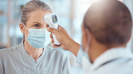 Image showing Woman in face mask, doctor and thermometer in office for covid test, safety and healthcare in hospital consultation. Temperature check, corona and patient at clinic with medical professional for exam