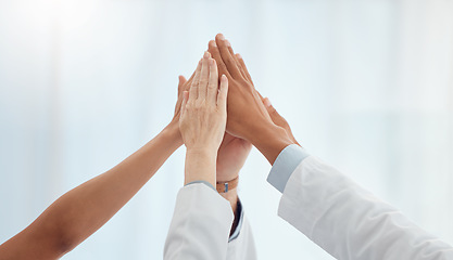 Image showing Closeup, doctors and nurses in hospital high five hands for team building success, motivation or healthcare support. Diversity, medical and people in achievement, collaboration and winner celebration