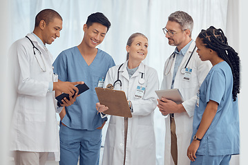Image showing Group of happy doctors, nurses and checklist in hospital, meeting and planning surgery or team schedule. Healthcare, discussion and medical staff with smile, feedback and talking together in clinic.