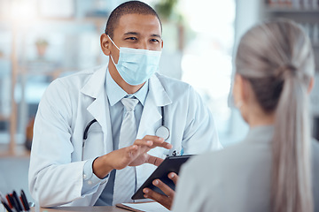 Image showing Tablet, face mask and doctor consulting a patient in a health conversation or communication during medical consultation. Medicine, healthcare and professional talking to person for results in clinic