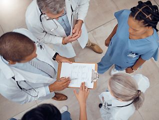 Image showing Group of doctors, nurses and checklist in hospital from above, meeting and planning surgery or schedule. Healthcare, discussion and medical staff with clipboard, info and talking together in clinic.