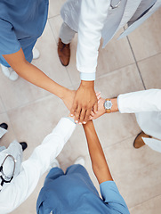 Image showing Motivation, teamwork or hands of doctors in hospital for healthcare goals, unity or solidarity together. Clinic, top view or medical nurses with group support, trust or wellness mission in clinic