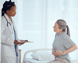 Image showing Medical, consultation and doctor with mature patient in discussion on chest pain problem. Professional, clipboard and female healthcare worker talking to elderly woman with heart sickness in hospital