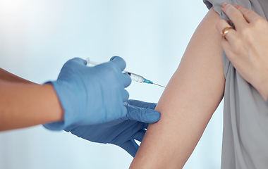 Image showing Doctor, arm injection and vaccine for patient in healthcare clinic, virus protection and wellness services. Closeup of needle, hands of medical nurse and medicine for safety, risk and sick immunity