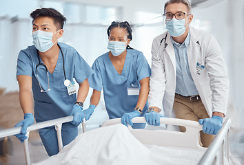 Image showing Rush, bed and doctors in hospital for emergency operation in ER with a sick patient or face mask. Surgery team, pushing or surgeons in the theater for surgical medicine procedure or risk treatment