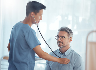 Image showing Doctor, asian man and listening with stethoscope to patient heartbeat, healthcare consultation and cardiology test in clinic. Medical worker check heart, lungs and breathing assessment in hospital