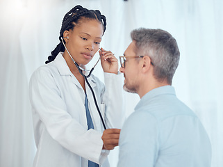 Image showing Doctor, black woman listening with stethoscope to patient heartbeat, healthcare services and cardiology assessment in clinic. Medical worker check heart, lungs and breathing test of man in hospital