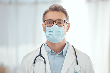 Image showing Man, portrait and doctor with face mask in hospital for medical services, surgery and wellness consulting. Male surgeon, mature therapist and healthcare manager working with safety ppe in clinic