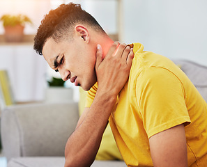 Image showing Man, sofa and neck pain in home, massage and relief from stress or injury in living room. Health, wellness and self care, person on couch with muscle problem, fatigue or physical therapy in apartment