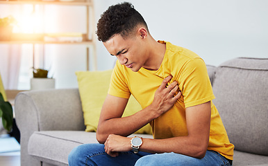 Image showing Man, sofa and chest pain in home, massage and relief from stress or injury in living room. Health, wellness and self care, person on couch with asthma, heartburn or breathing problem in apartment