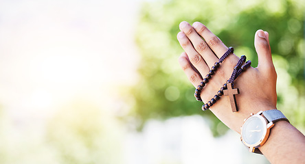 Image showing Faith, hands praying and rosary in garden with mockup, praise and religion with holy mindset. Christian prayer beads, cross and person in worship in nature with hope, spiritual gratitude and space.