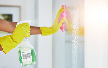 Image showing Window, spray and hands cleaning in a home for hygiene, germ protection and maintenance with a chemical in a house. Bacteria, glass and housekeeper or cleaner working on a wood desk with gloves