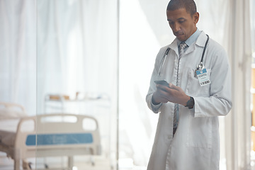 Image showing Man, doctor and phone in hospital for medicine research, healthcare and prescription email in telehealth consulting. Serious, biracial person and medical worker on mobile technology for clinic help